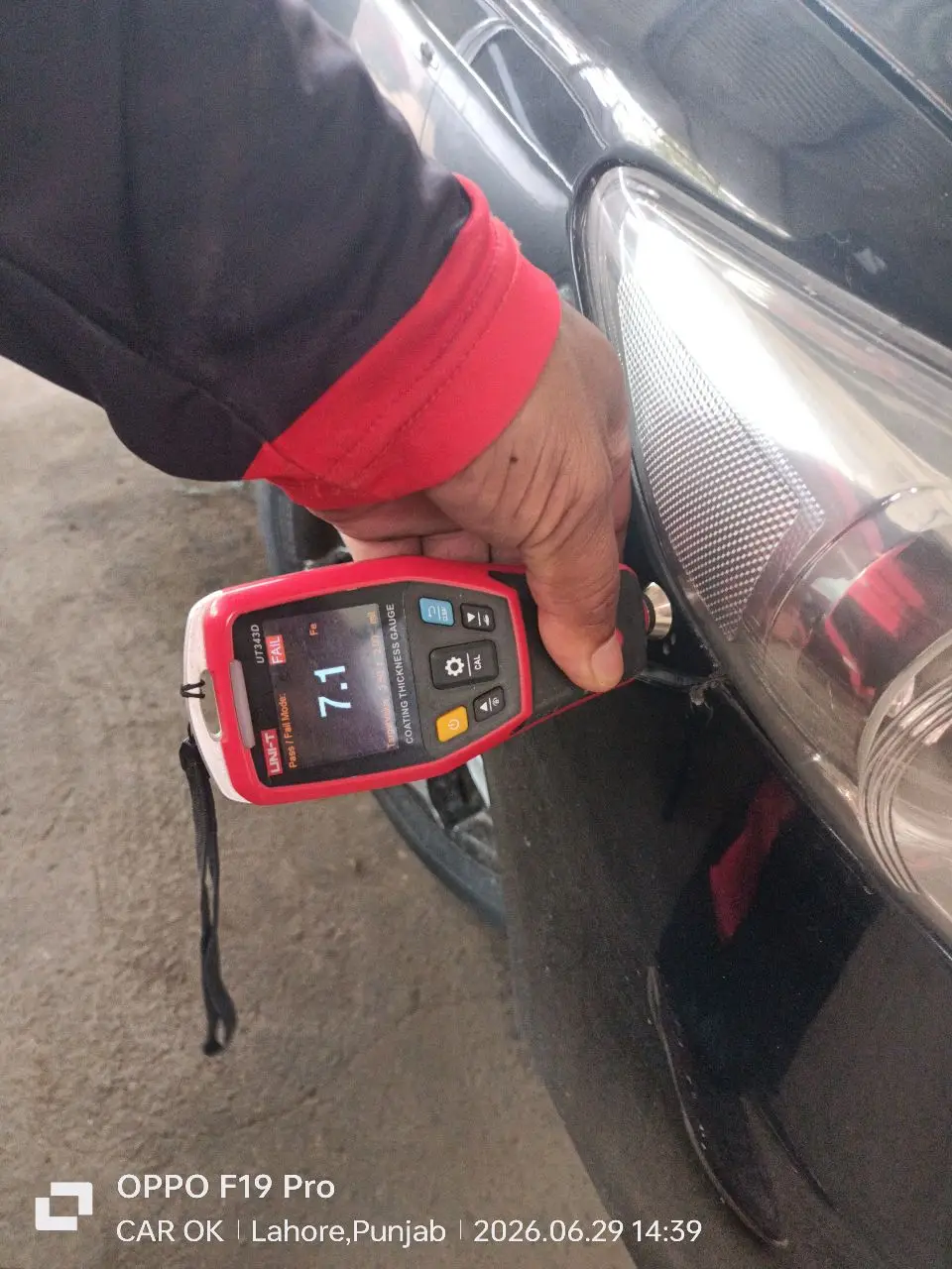 Paint-thickness gauge reading FAIL at 7.1 near the front end — repaint where the odometer said “barely driven”