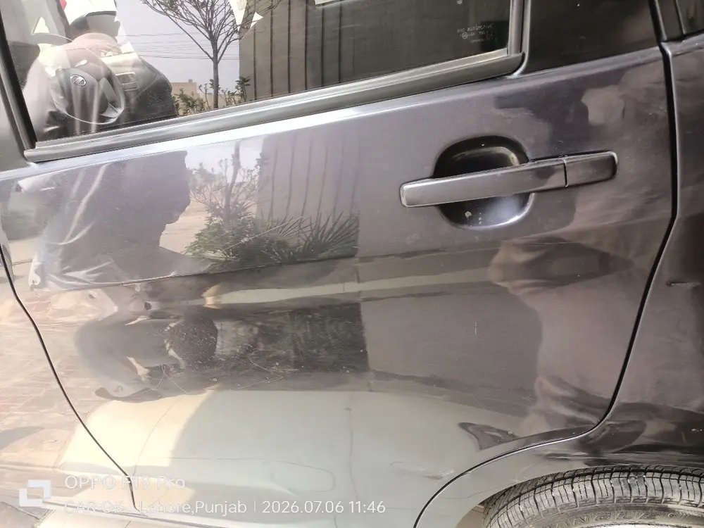 Dent + scratch on the rear door — two of 39 findings