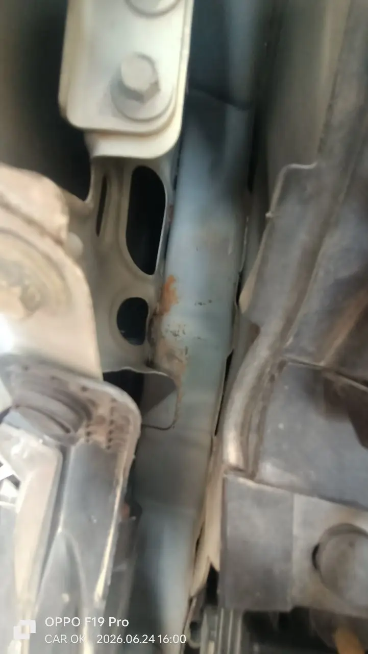 Behind the panels: corrosion and repair traces on a structural member — the accident story the shiny body hid