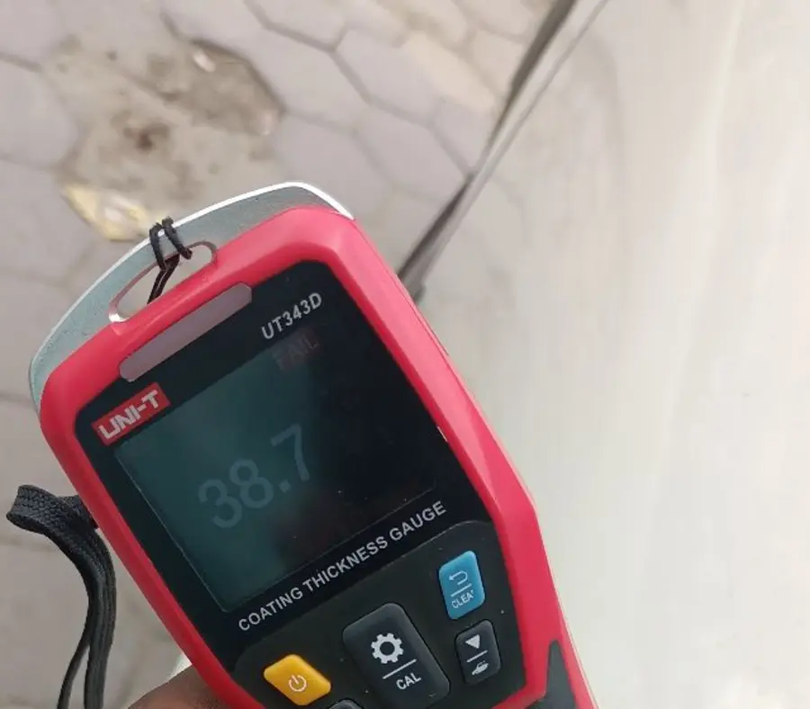 Paint-depth gauge reading FAIL on a car panel