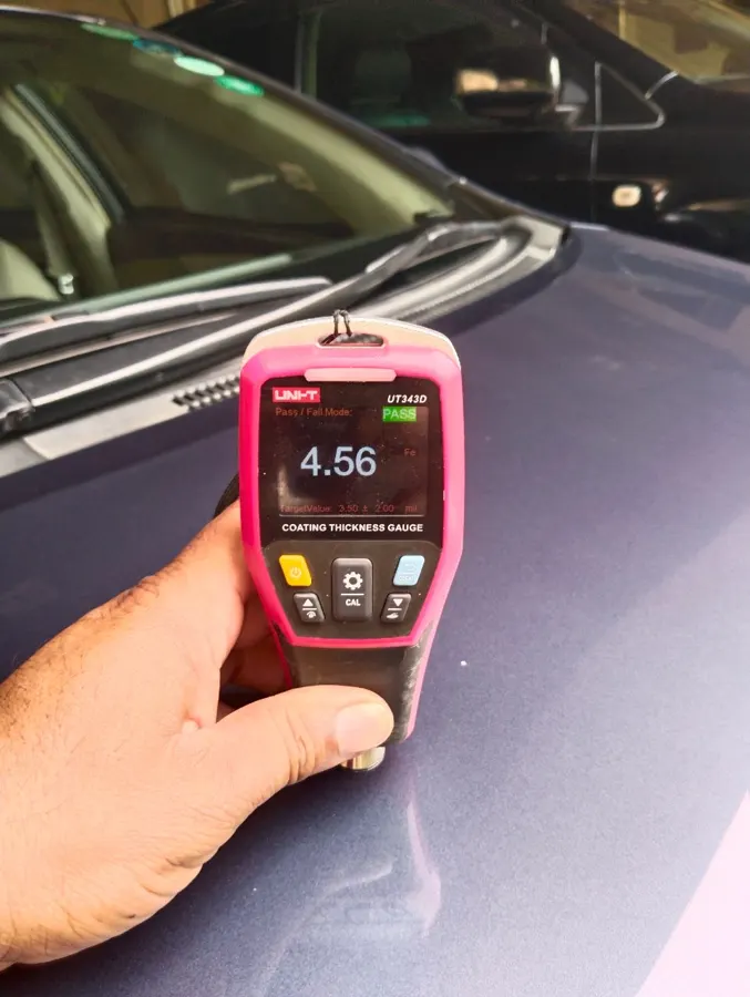 Paint thickness gauge reading 4.56 mils on an original panel